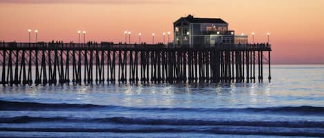 A pier extending into the water with a building at the end.