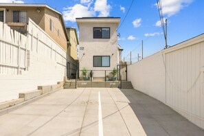 A residential building with a flat facade, a visible address number, and a gated entrance. - Brand New Condo Near Downtown, Coronado (San Diego)