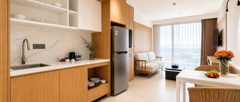 A modern kitchen with a built-in refrigerator, wooden cabinets, and a marble backsplash.