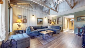 A spacious living area with a large sofa set, a coffee table, and a fireplace. - Seasons 4 #104 2 Bedroom Condo (Mammoth Lakes)