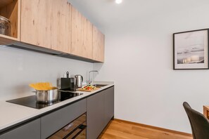 Coffee/tea maker, fridge, oven, stovetop - Modern Alpine Stay in San Bernardino | Ski, Hiking & Nature - Castanea 104, San Bernardino, Switzerland (San Bernardino)