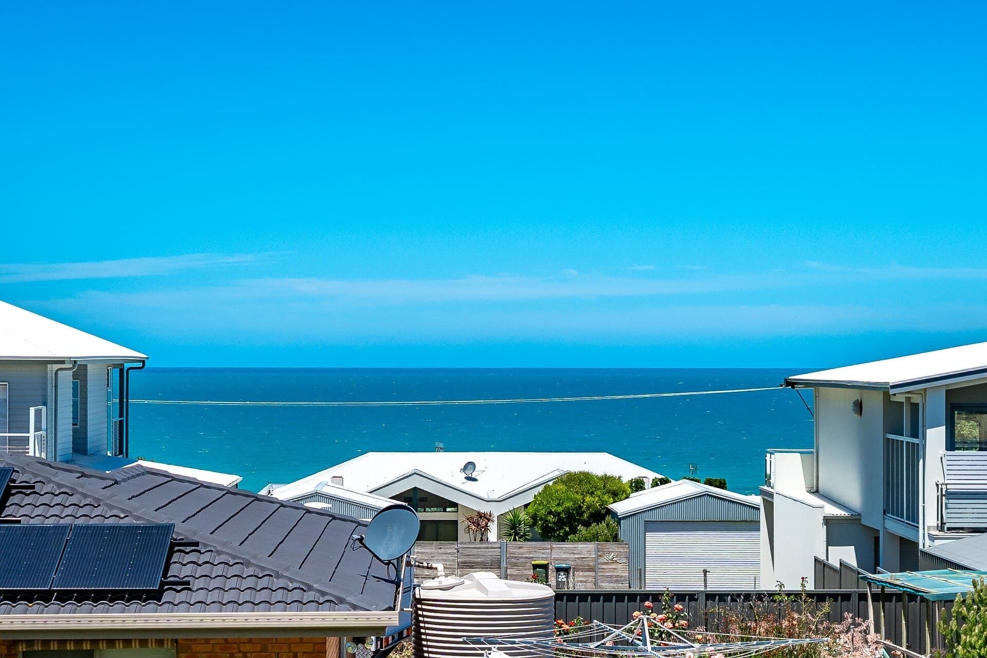 A residential area with houses overlooking a body of water.
