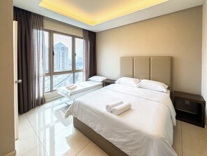A hotel room with a large bed, a bedside table, a window with curtains, and a view of the cityscape. - Dorsett Sri Hartamas by Airhost (Kuala Lumpur)