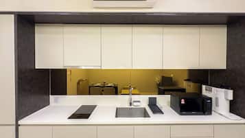 A modern kitchen with a built-in microwave, a sink, and a countertop.