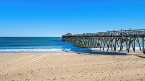 A beach with a wooden pier extending into the ocean. - Hang Ten House- 2.5 Blocks to Beach- Pet Friendly (Myrtle Beach)