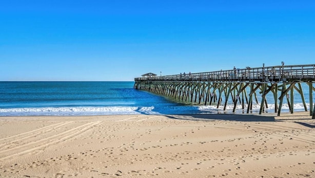 A beach with a wooden pier extending into the ocean. - Hang Ten House- 2.5 Blocks to Beach- Pet Friendly (Myrtle Beach)