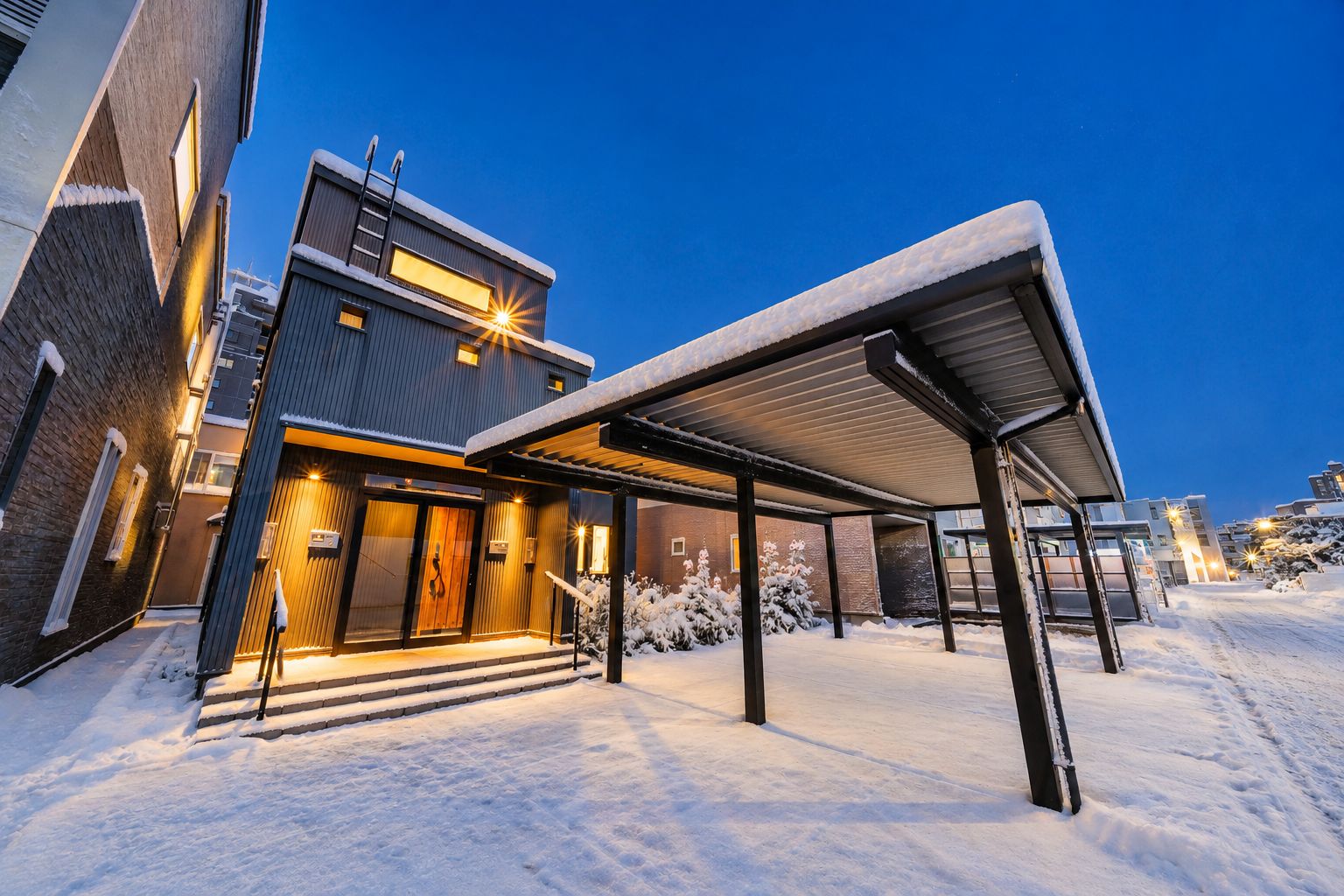 A modern building with a covered outdoor area and a snow-covered ground.