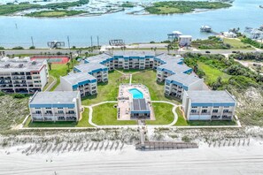 A beachfront hotel with multiple buildings, a central swimming pool, and a sandy beach area. - First Floor, Oceanfront, Direct Beach Access, Pristine Pool, Boat Ramp, Dock, $300 in Free Tickets! (St. Augustine)
