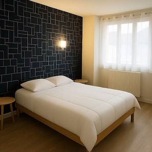 A bedroom with a bed, a nightstand, a wall-mounted light, and a window with curtains.