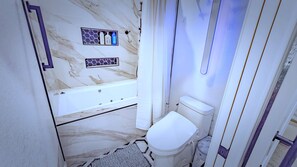 A bathroom with a marble wall, a bathtub, a toilet, and a shower curtain. - Fully renovated and Spacious 4-bedroom 3 baths house (Upland)