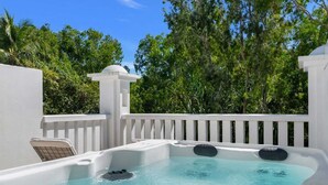 A hot tub with a white exterior, surrounded by a white fence, and trees in the background. - 3434 Peppers Spa Penthouse (Palm Cove)