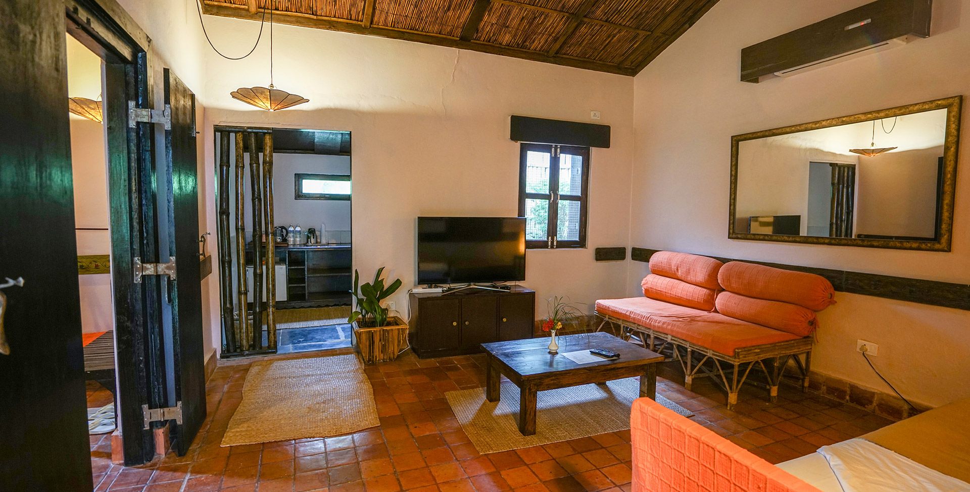 A living room with a television, sofa, and a dining table.