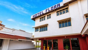 A two-story building with a sign reading 'HOTEL FLORA' at the top. - Hotel O near RS Awal Bros Sudirman (Pekanbaru)