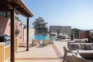 A rooftop pool area with lounge chairs, a barbecue grill, and a view of the sea. - Casa Dell' Aristea, a Private Venetian Manor (Rethymno)
