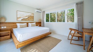 A bedroom with a large bed, a desk, and a window with curtains. - Rocha Villa Uluwatu (Uluwatu)