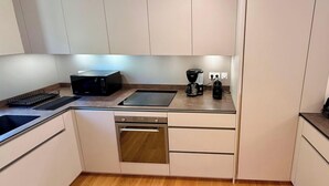 A modern kitchen with a built-in microwave, coffee maker, and dishwasher. - Le Belvédère de La Montille (sleeps 6) (Mont-Dore)