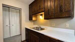 A kitchen with wooden cabinets, a white countertop, and a stainless steel sink. - St. Paul Cozy Home Stay-Pets Ok, Pool & GYM Access - 79/Night, 1,750/Month (Saint Paul)