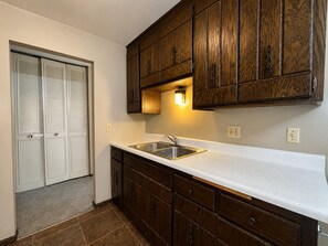A kitchen with wooden cabinets, a white countertop, and a stainless steel sink. - St. Paul Cozy Home Stay-Pets Ok, Pool & GYM Access - 79/Night, 1,750/Month (Saint Paul)