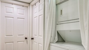 A white door with a handle and a white closet with a shelf. - Weeki Wachee Springs Gem: Relax and Explore (Spring Hill)