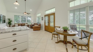A spacious kitchen with a marble countertop, a ceiling fan, and large windows. - On 174 Acres! Ranch House in Colorado County (Weimar)