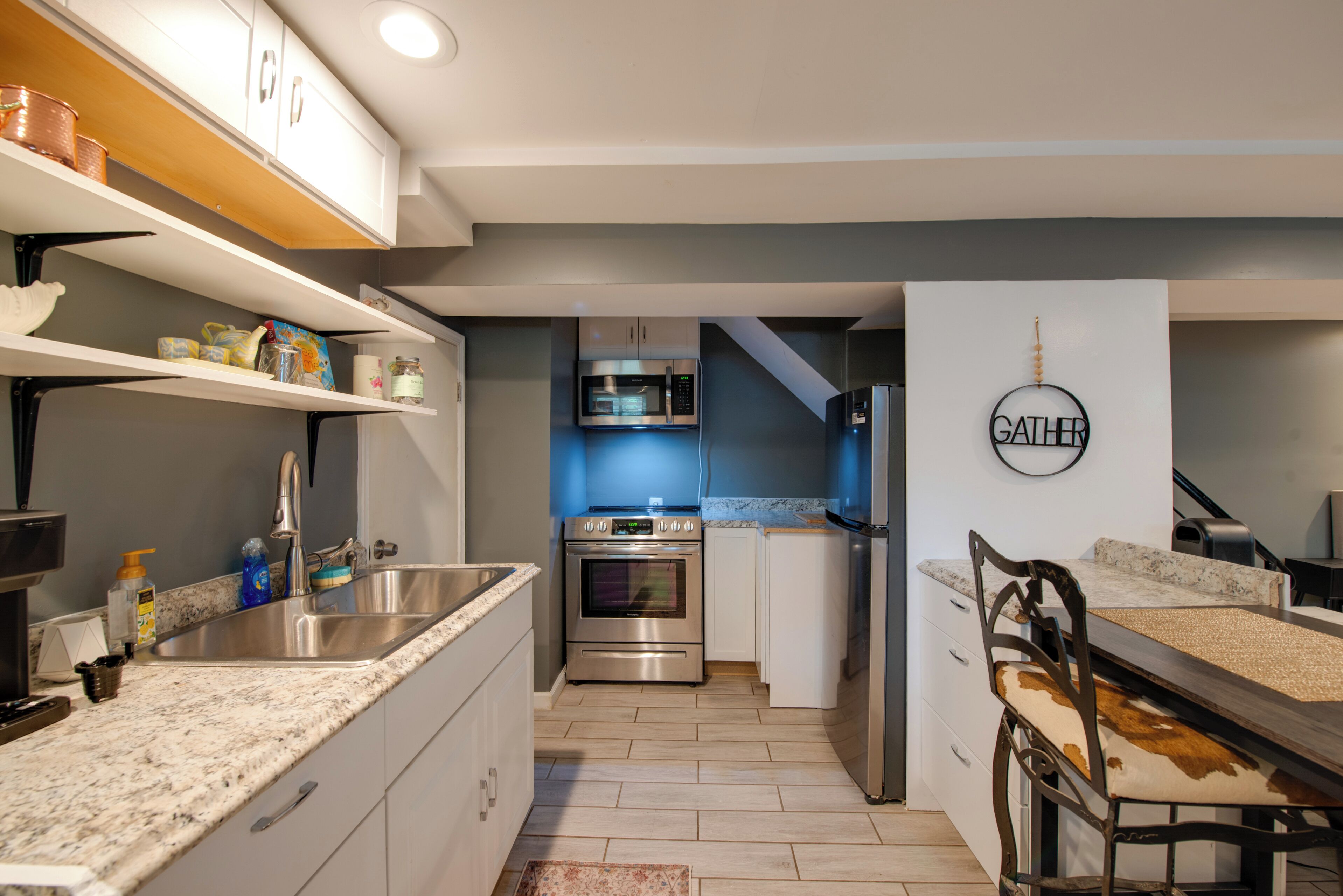 A modern kitchen with stainless steel appliances, a built-in oven, and a microwave.