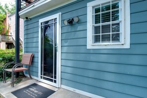 A residential building with a sliding glass door, a small window, and a welcome mat. - Remote Work Haven! Studio 8 Mi to Lincoln Memorial (Washington)