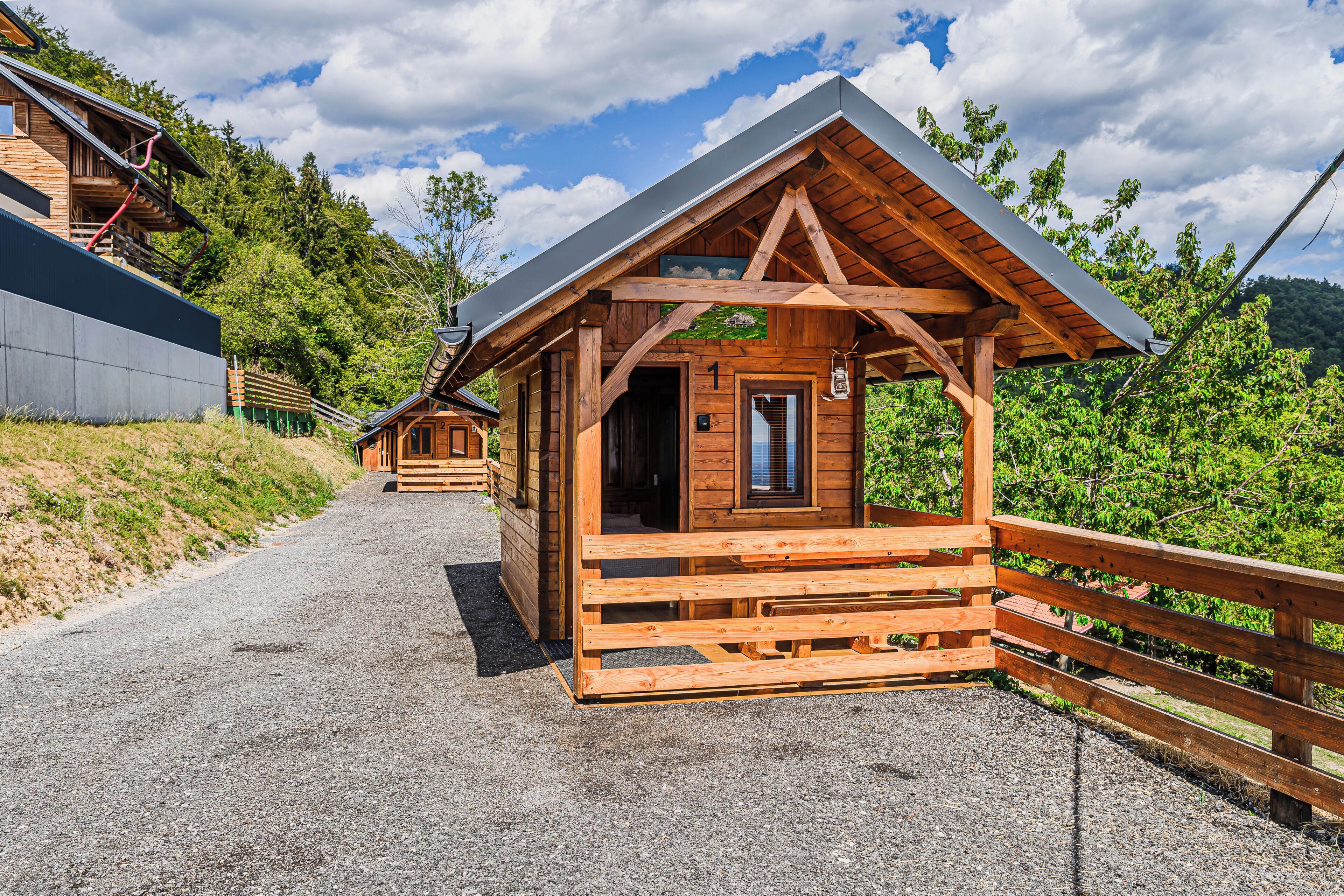 A wooden cabin with a sloped roof, a door, and a window.