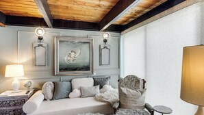 A cozy room with a sofa, a decorative chair, a globe, and a framed painting on the wall. - Award-Winning Mr Mid-Modern-Century (Iowa City)