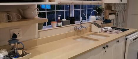 A modern kitchen with a microwave, sink, and cabinets.