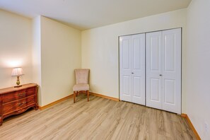 A room with a wooden dresser, a chair, and a double door. - Great for Families! Spacious Retreat in Lynnwood (Lynnwood)