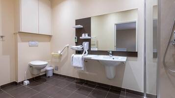 Een moderne badkamer met toilet, wastafel en douche.
