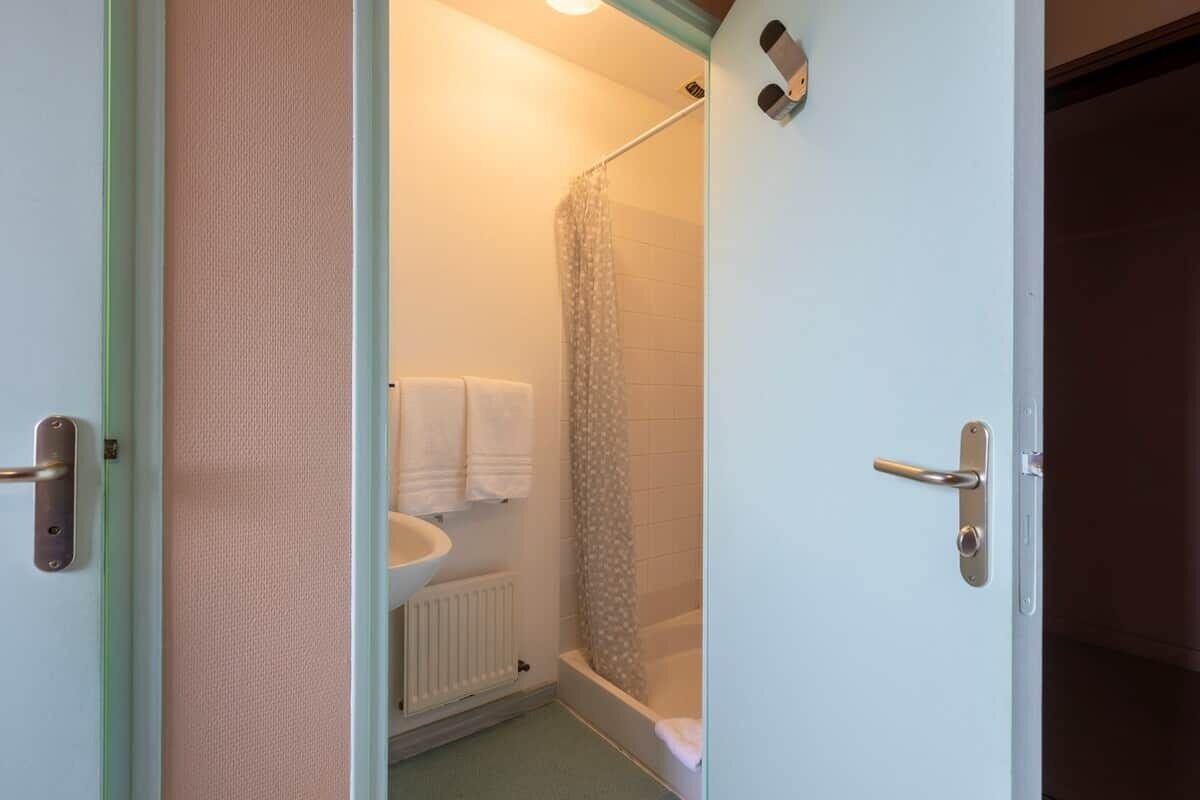 Une salle de bain avec une douche, des toilettes et un lavabo.