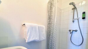 A bathroom with a shower, a towel rack with two towels, and a soap dispenser on the wall. - Room 202 - Le Bas Mont Residence (Moulay)