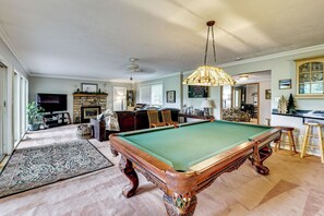 A billiards room with a pool table, a fireplace, and a television. - Game Room, Deck + Yard! Cadillac Family Escape (Cadillac)