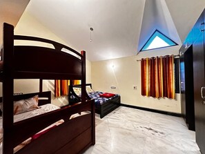 A bedroom with a bunk bed, a single bed, a wardrobe, a ceiling light, and a window with curtains. - Spacious 5-bedroom bungalow in gorgeous Chennai with AC (Chennai)