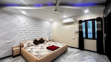 A modern bedroom with a bed, a nightstand, a ceiling fan, and a window with curtains.