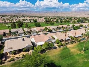 A residential area with houses, a golf course, and mountains in the background. - Golf Views + BBQ Patio | Mins to Indian Wells | Palm & Par (Palm Desert)