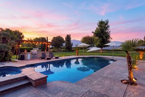 A swimming pool with a barbecue area and lounge chairs. - 20 Acres • Lake + Pool + Spa • Near Hard Rock Casino | Vista del Lago Estate (Bakersfield)