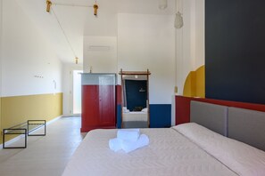 Ein Hotelzimmer mit Bett, Schrank und Spiegel.