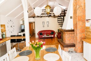 A modern interior with a dining area, kitchen, and living space. - Mrzezyno Holiday Home, for 4 People (Trzebiatow)