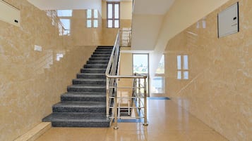 A staircase with a metal railing leading to an upper floor.
