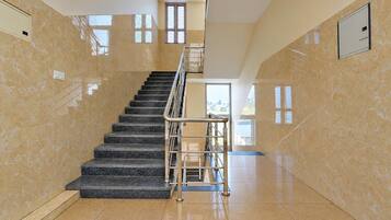 A staircase with a metal railing leading to an upper floor.