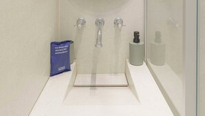 A modern bathroom with a large mirror, a sink, and a toilet. - 1bdr/3p Flat - Balcony - in the Heart of Deauville (Deauville)