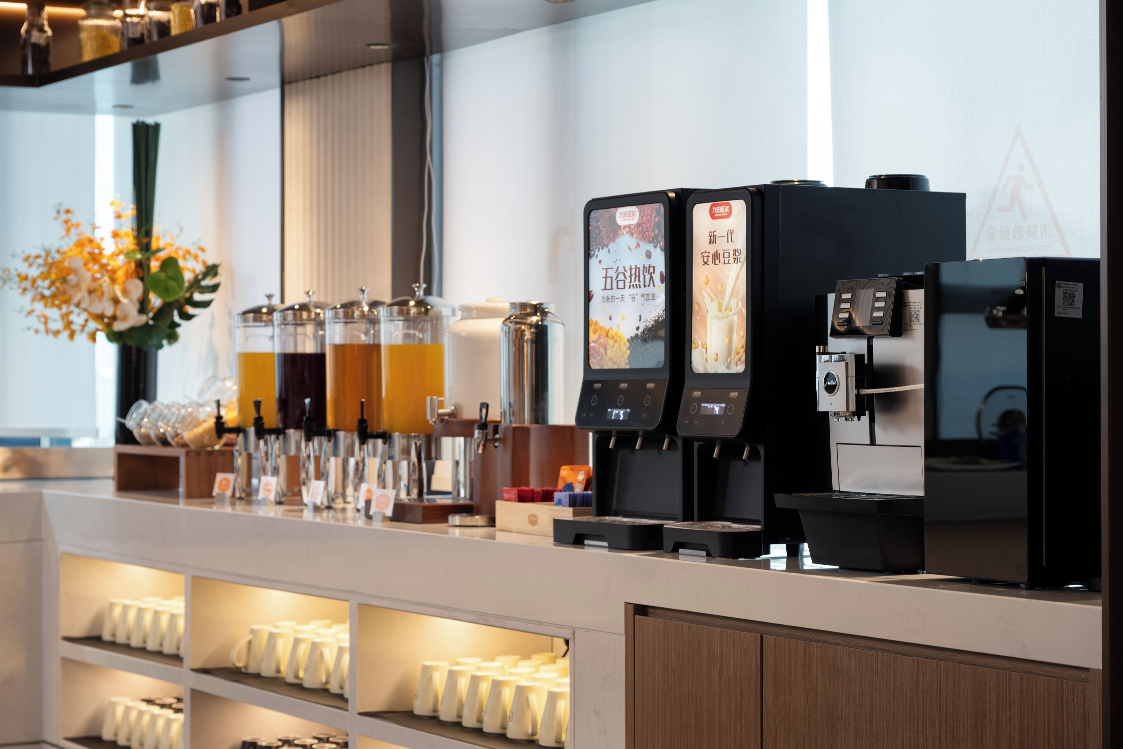 A coffee bar with multiple dispensers and a selection of beverages.