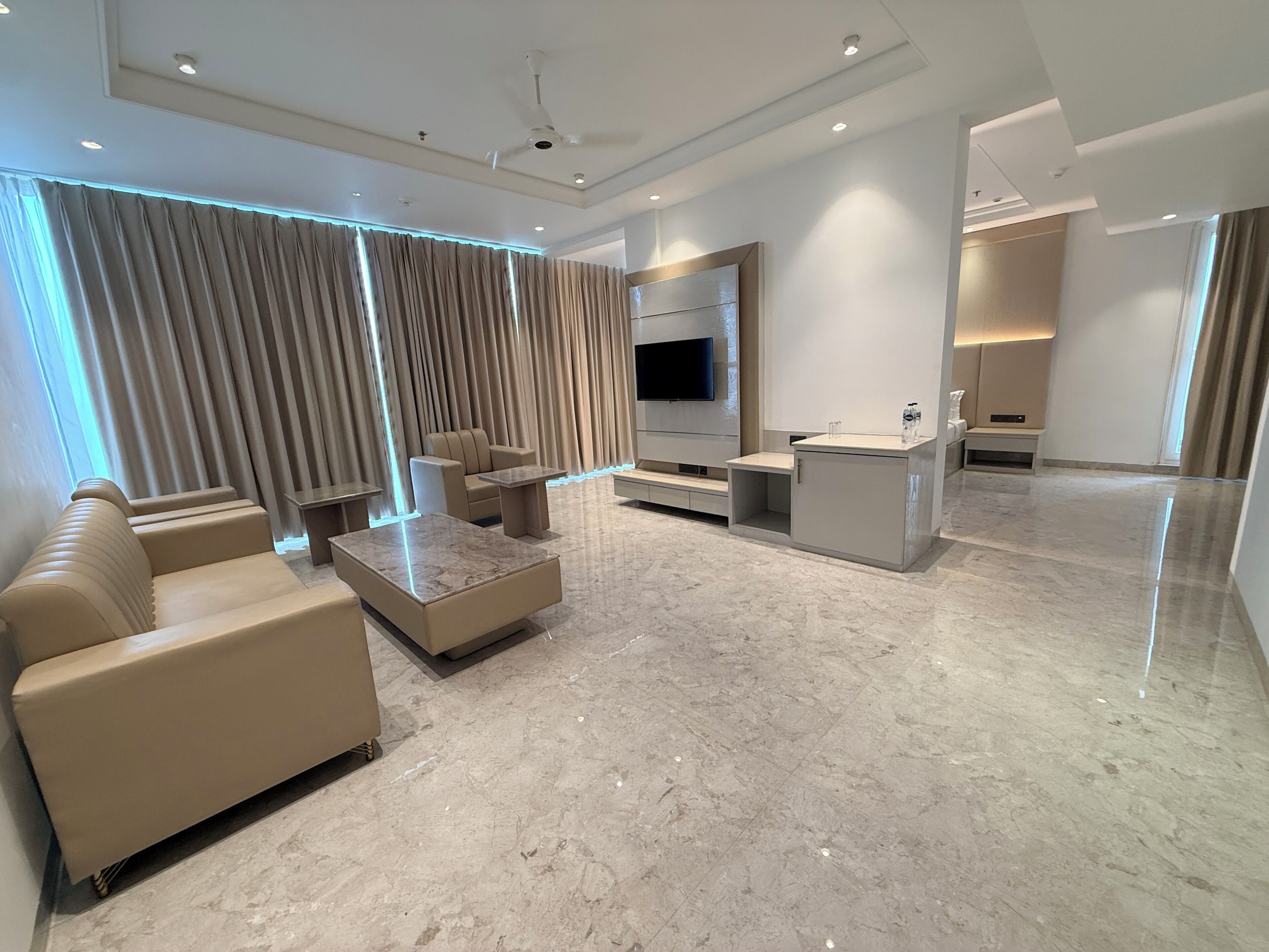 Un salon moderne avec un canapé, une table basse et un téléviseur.