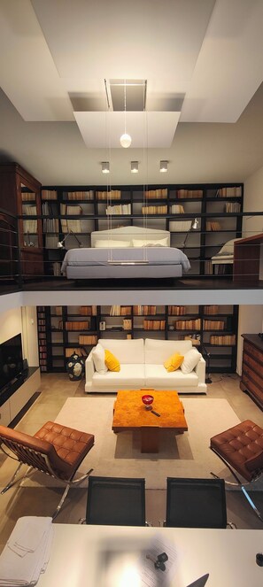 A modern living room with a sofa, coffee table, and bookshelves. - Loft, a designer apartment in a prime downtown location (Milano)