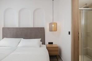 A bedroom with a bed, bedside table, and a shower area. - Gaia Villas - With 2 Private Pools (Bali)