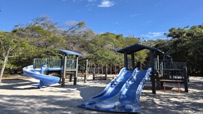 A playground with two slides and a climbing structure. - TREE TOP BREEZE - SUNRISE AT 1770 (AGNES WATER)