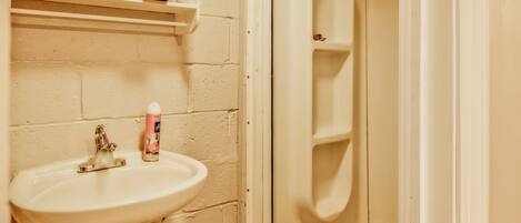 A bathroom with a white sink, a toilet, and a bathtub.