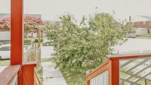 A residential area with a wooden fence, a tree, and a parked car. - Essex Smart Stay (Essex)